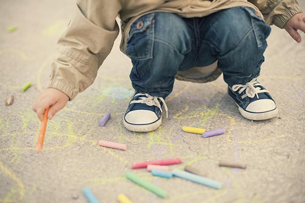 boy drawing with chalks